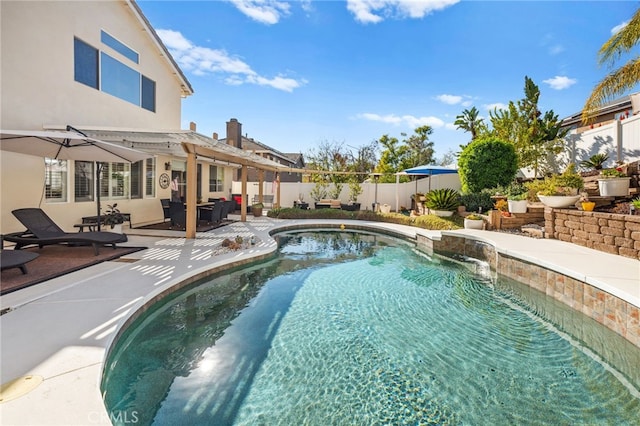 view of pool with pool water feature and a patio area