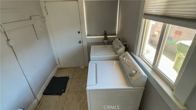 washroom with washer and dryer and light tile patterned floors