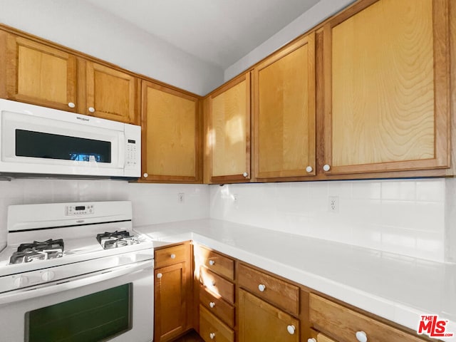 kitchen with decorative backsplash and white appliances