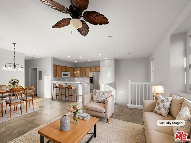 tiled living room featuring a chandelier