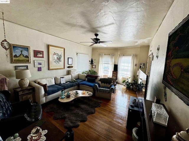 living room featuring ceiling fan and wood-type flooring