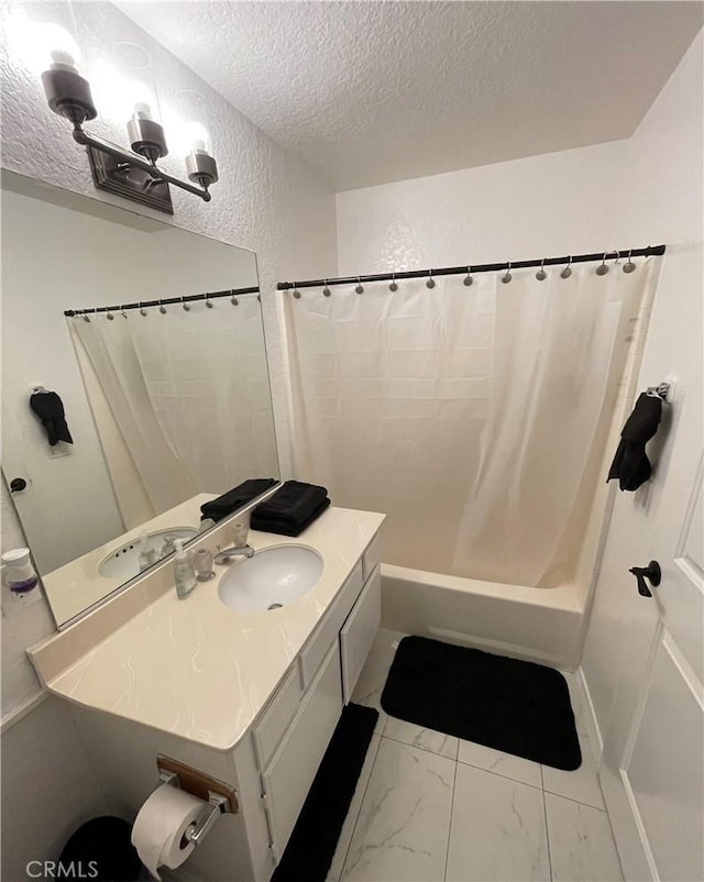 bathroom featuring a textured ceiling, vanity, and shower / tub combo