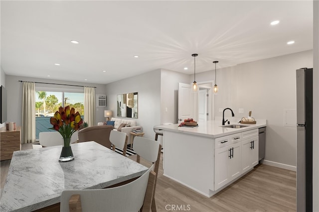 dining space with light hardwood / wood-style floors and sink