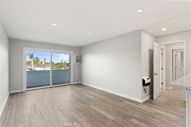 unfurnished room featuring light wood-type flooring, baseboards, and recessed lighting