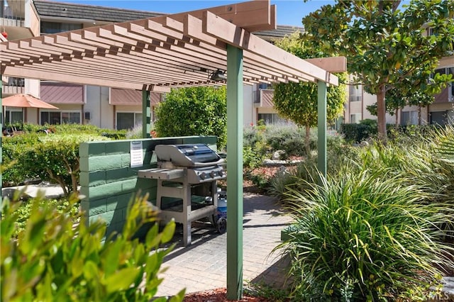 view of patio / terrace featuring area for grilling and a pergola