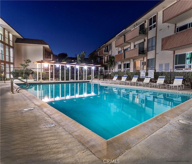 pool at night with fence and a community pool