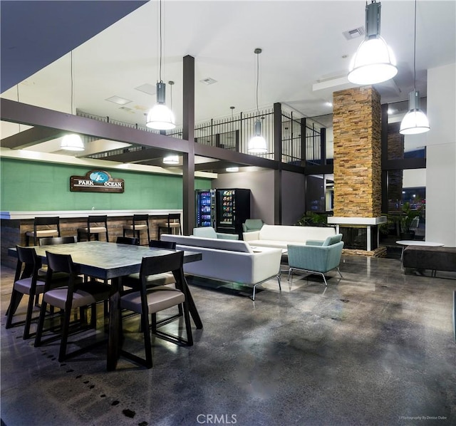 dining space featuring a towering ceiling and visible vents