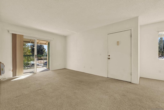 interior space with a textured ceiling and carpet floors