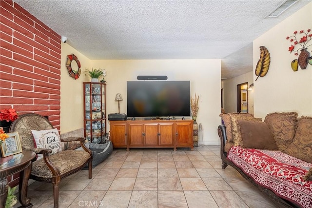 living room featuring light tile patterned floors and a textured ceiling