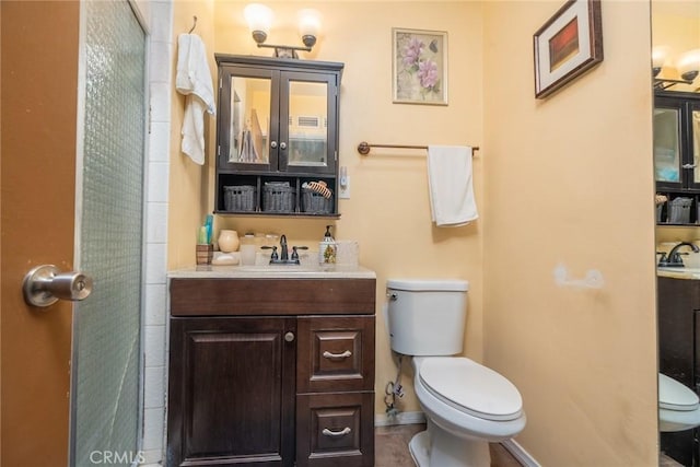 bathroom with toilet and vanity