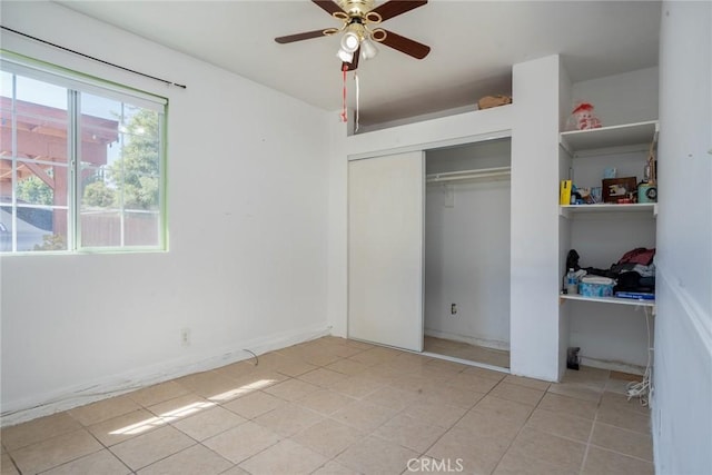 unfurnished bedroom with a closet and ceiling fan