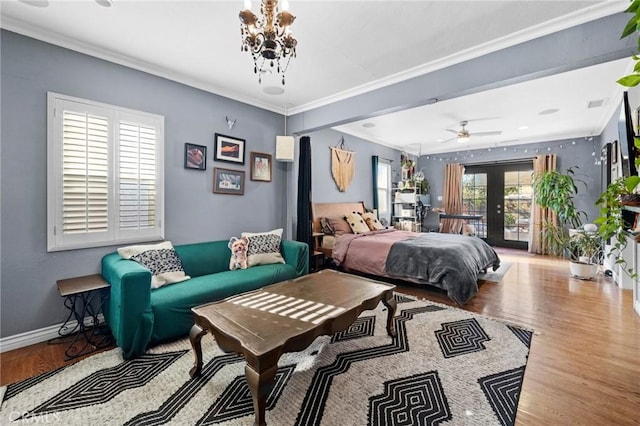 bedroom featuring french doors, hardwood / wood-style flooring, multiple windows, and ornamental molding