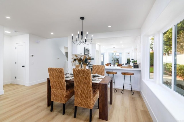 dining space featuring a chandelier and light hardwood / wood-style floors