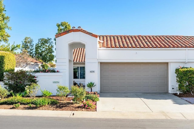 mediterranean / spanish-style home featuring a garage