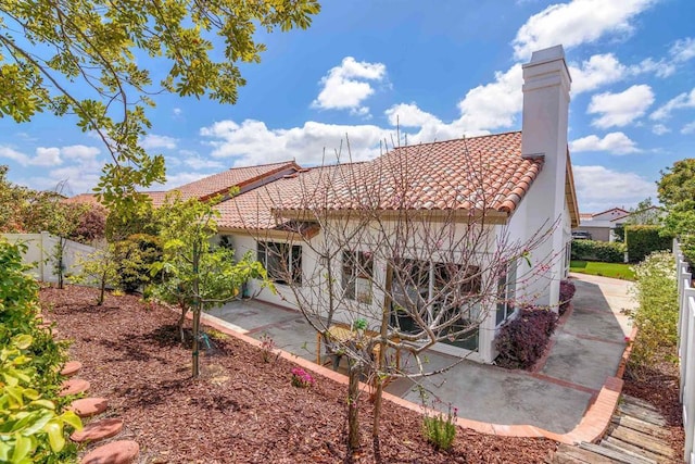 back of property with a patio