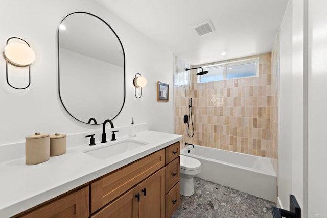 full bathroom featuring vanity, toilet, and tiled shower / bath