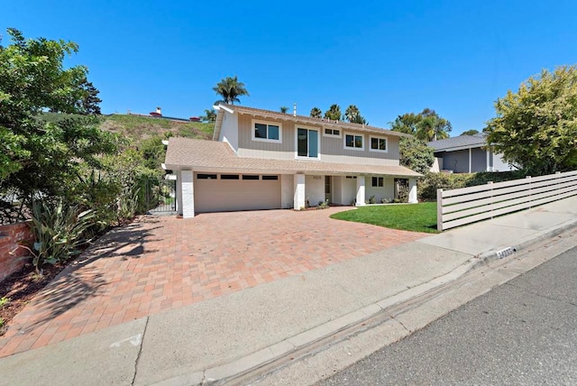 view of front of home featuring a garage and a front lawn