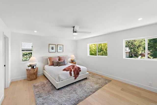 bedroom with ceiling fan and light hardwood / wood-style flooring