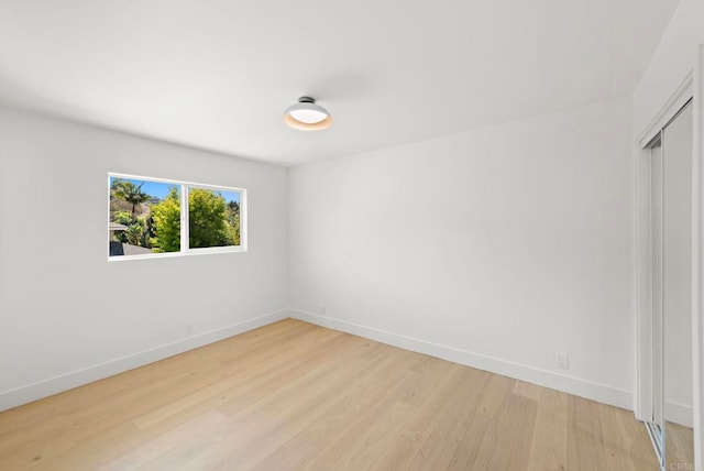 spare room with light hardwood / wood-style floors