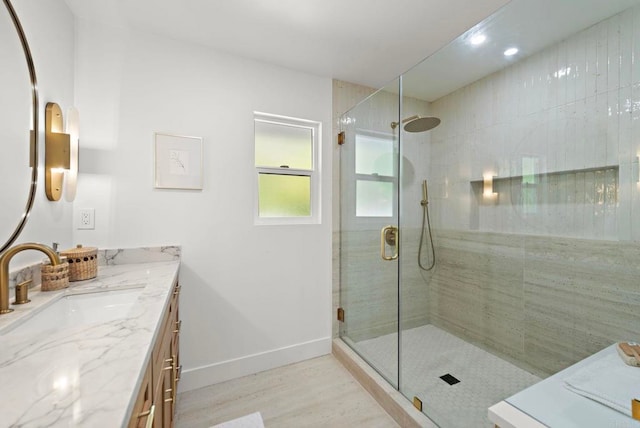 bathroom featuring hardwood / wood-style floors, vanity, and walk in shower