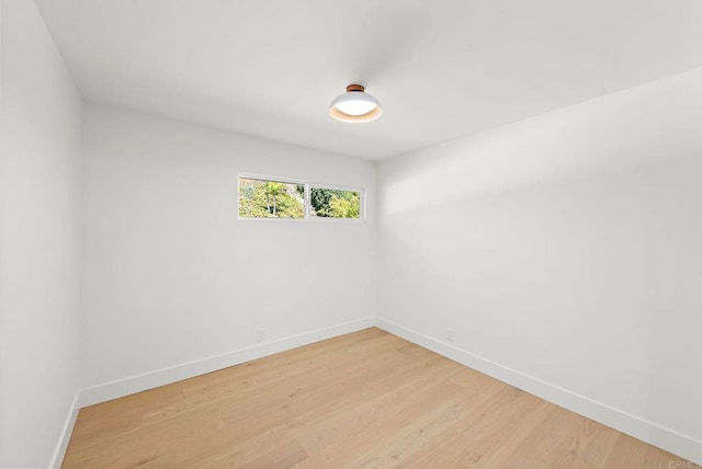 spare room with wood-type flooring