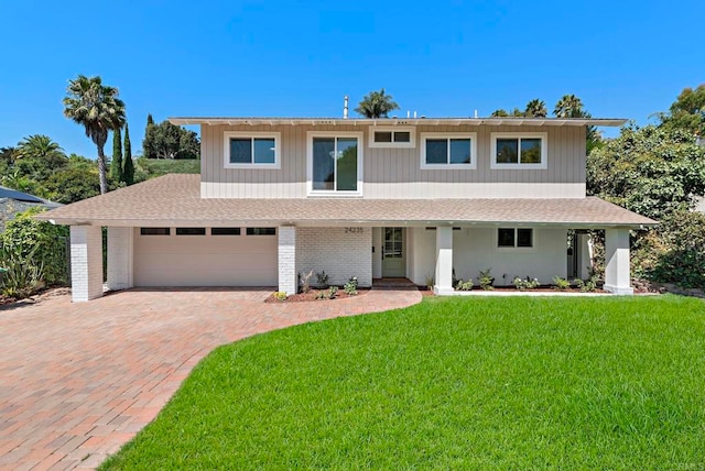 view of front of property featuring a garage and a front yard