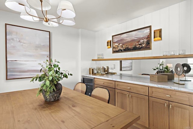 interior space featuring beverage cooler and a chandelier