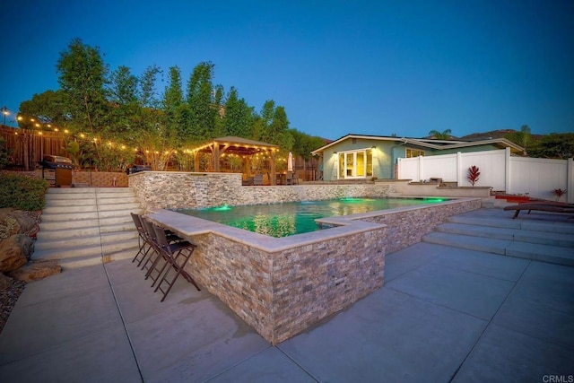 view of pool featuring an outdoor bar and a patio