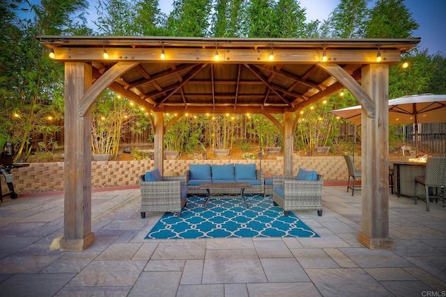 patio terrace at dusk featuring a gazebo and outdoor lounge area