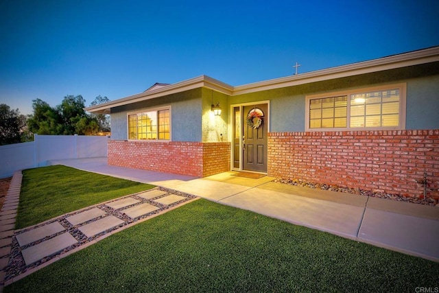 view of front of house with a yard