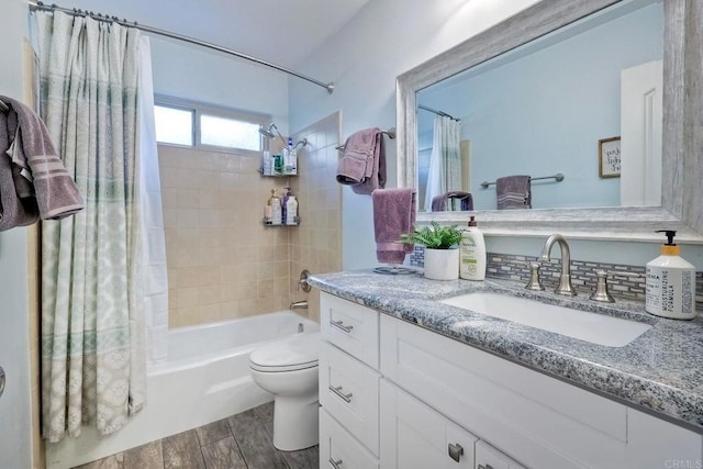 full bathroom featuring vanity, toilet, and shower / tub combo with curtain