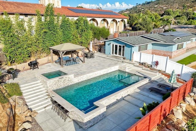 view of swimming pool with an outdoor structure, grilling area, a gazebo, a patio area, and an in ground hot tub