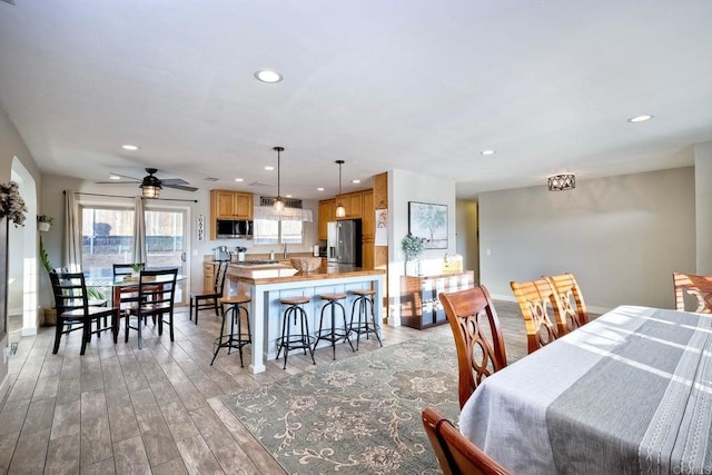 dining space featuring ceiling fan and light hardwood / wood-style floors