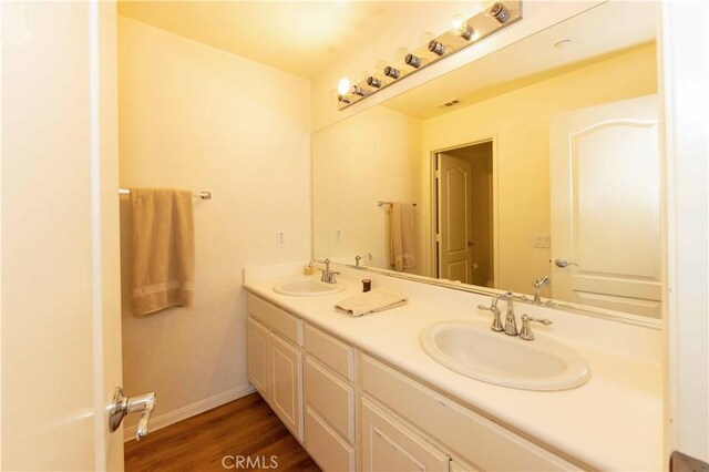 bathroom with wood-type flooring and vanity