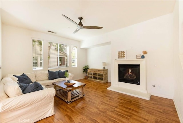 living room with hardwood / wood-style floors and ceiling fan