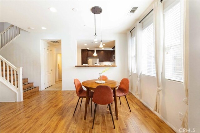 dining space with light wood-type flooring