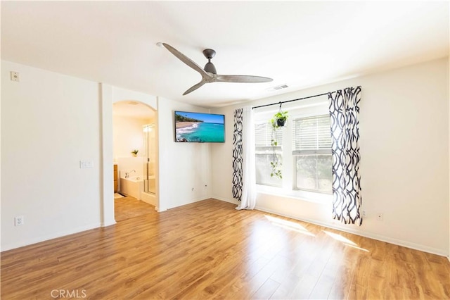 spare room with ceiling fan and light wood-type flooring