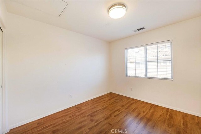 empty room with hardwood / wood-style floors