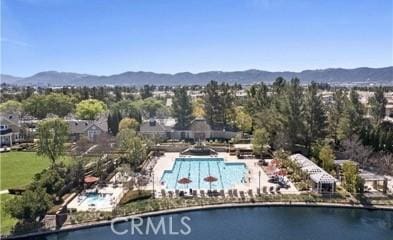 drone / aerial view featuring a water and mountain view