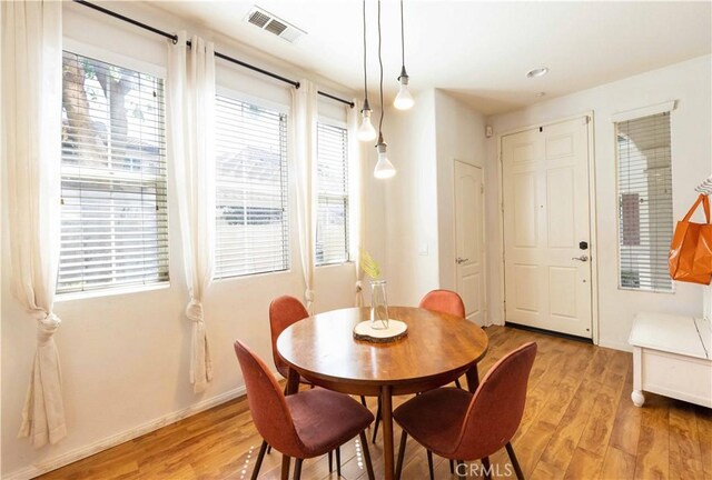 dining area featuring plenty of natural light and light hardwood / wood-style floors