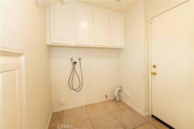 laundry room with cabinets, hookup for a gas dryer, hookup for a washing machine, and light tile patterned floors