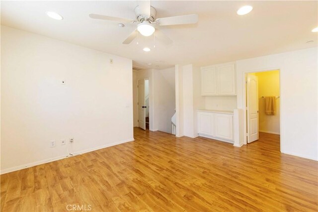 unfurnished room with ceiling fan and light hardwood / wood-style flooring