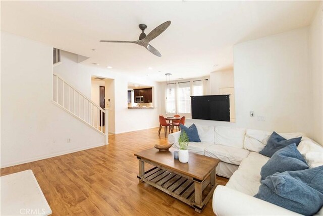 living room with ceiling fan and light hardwood / wood-style floors