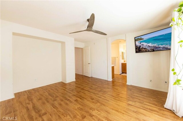 spare room with light hardwood / wood-style flooring and ceiling fan