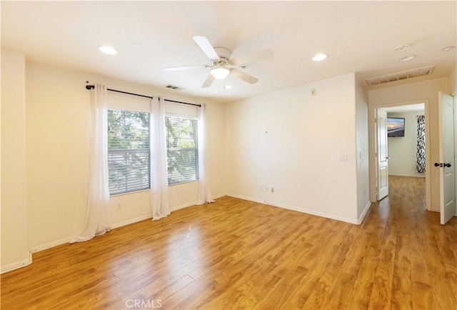 unfurnished room featuring ceiling fan and light wood-type flooring