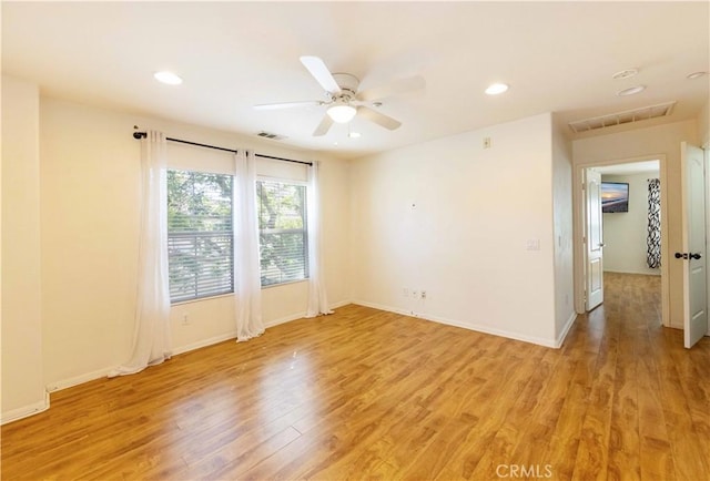 empty room featuring light hardwood / wood-style flooring and ceiling fan