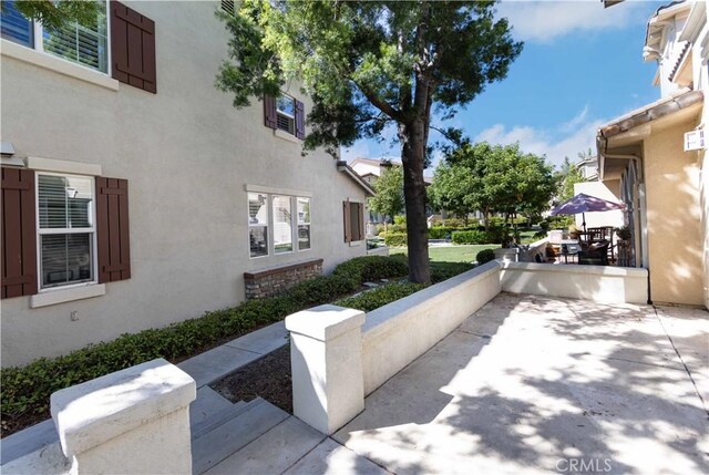 view of side of home featuring a patio area