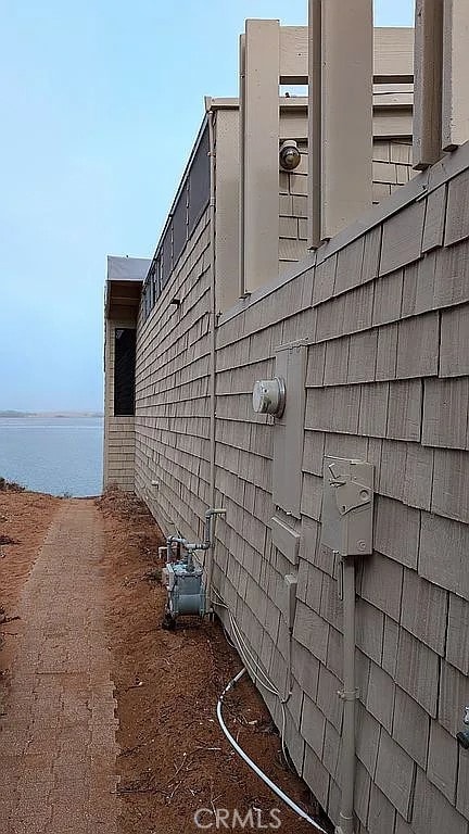 view of side of home with a water view