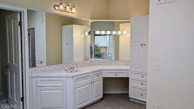 bathroom with vanity and backsplash