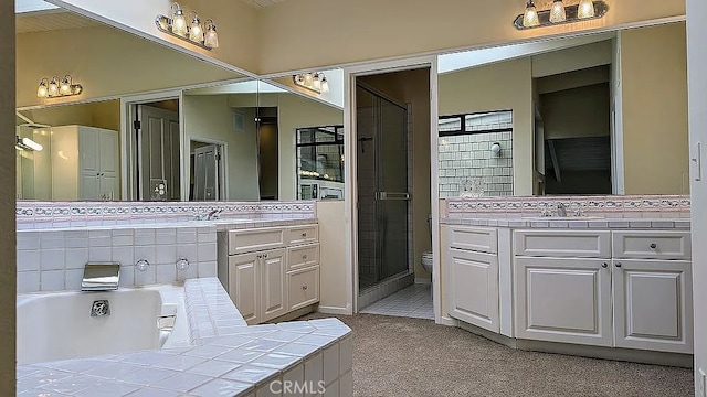 full bathroom featuring shower with separate bathtub, vanity, and toilet